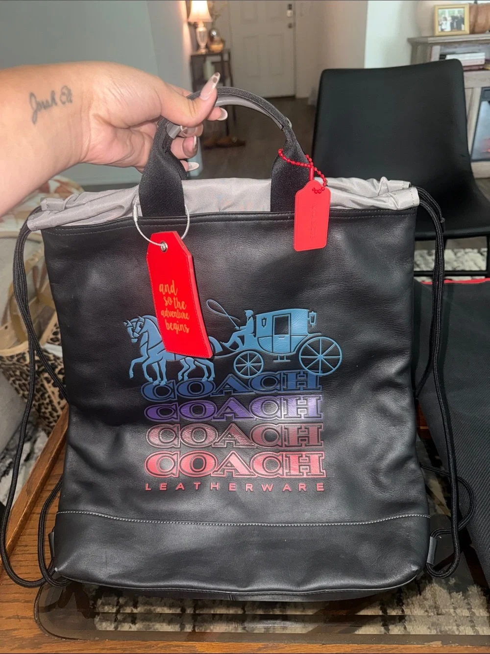 Coach Black Leather Drawstring Backpack with Blue-Purple-Red Gradient Logo